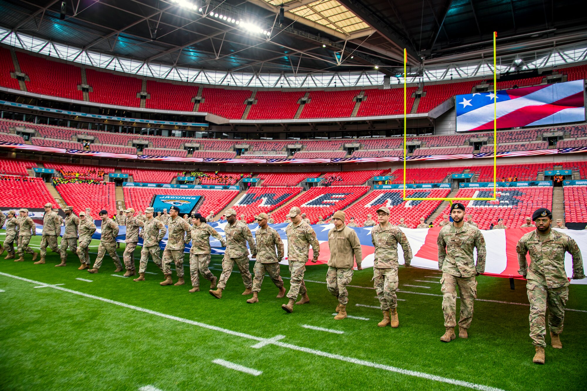 Airmen from the 501st Combat Support Wing rehearse unveiling an American flag at Wembley Stadium, in London, England, Oct. 30, 2022. Approximately 70 uniformed personnel represented the U.S. Air Force and nation by unveiling an American flag during the pre-game ceremonies of the Jacksonville Jaguars and Denver Broncos NFL game. (U.S. Air Force photo by Staff Sgt. Eugene Oliver)