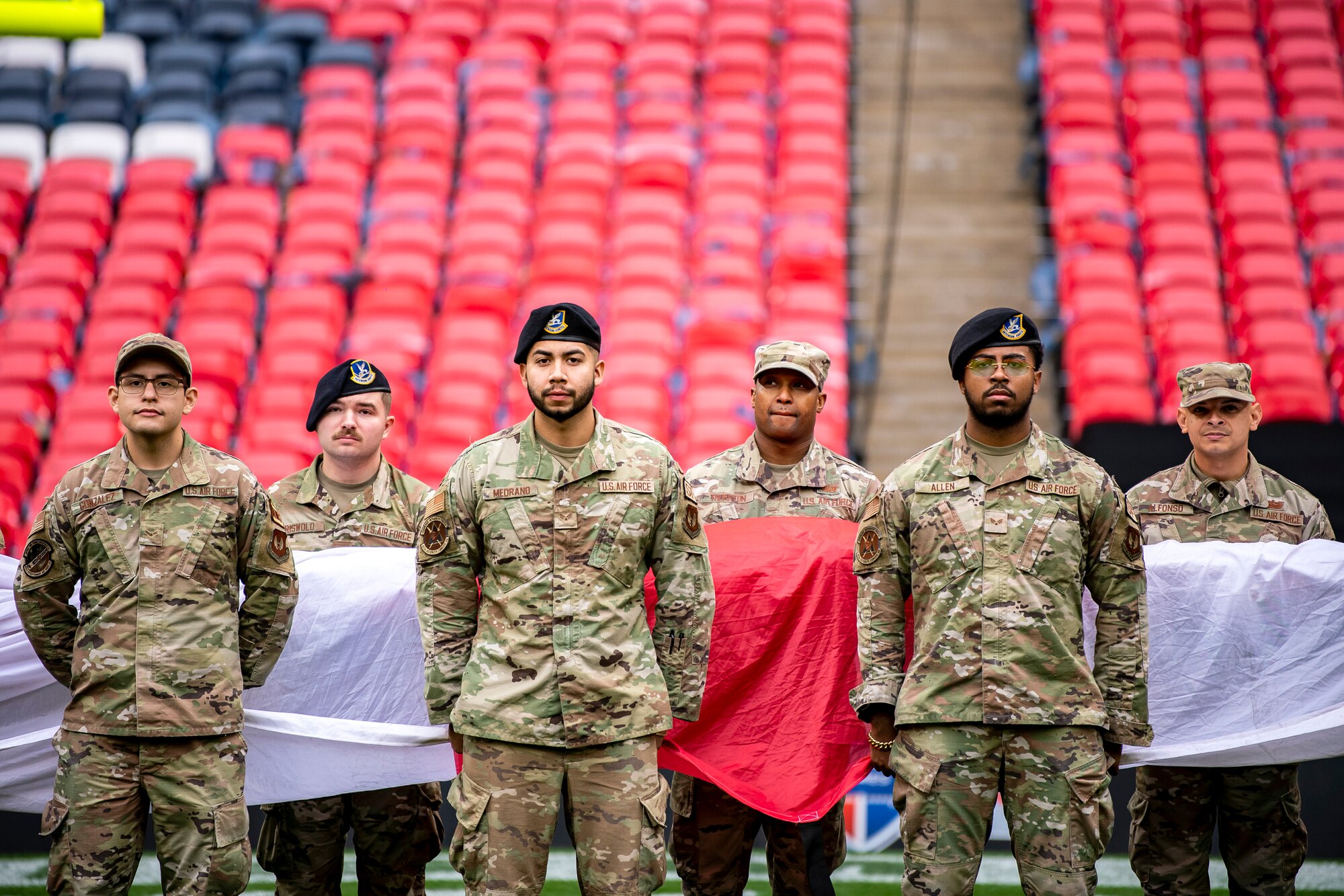 Airmen from the  501st Combat Support Wing stand at attention during a national anthem rehearsal at Wembley Stadium, in London, England, Oct. 30, 2022. Approximately 70 uniformed personnel represented the U.S. Air Force and nation by unveiling an American flag during the pre-game ceremonies of the Jacksonville Jaguars and Denver Broncos NFL game. (U.S. Air Force photo by Staff Sgt. Eugene Oliver)