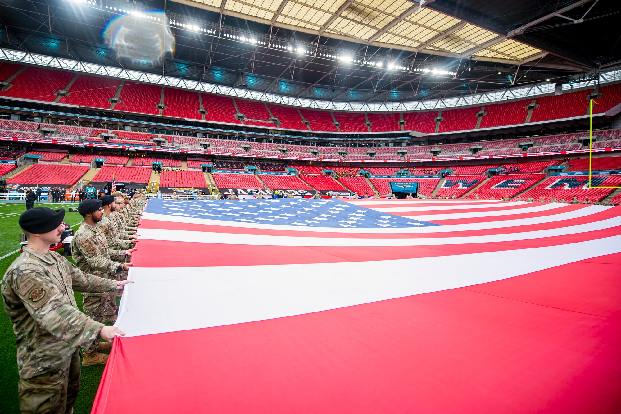 Airmen from the 501st Combat Support Wing rehearse unveiling an American flag at Wembley Stadium, in London, England, Oct. 30, 2022. Approximately 70 uniformed personnel represented the U.S. Air Force and nation by unveiling an American flag during the pre-game ceremonies of the Jacksonville Jaguars and Denver Broncos NFL game. (U.S. Air Force photo by Staff Sgt. Eugene Oliver)