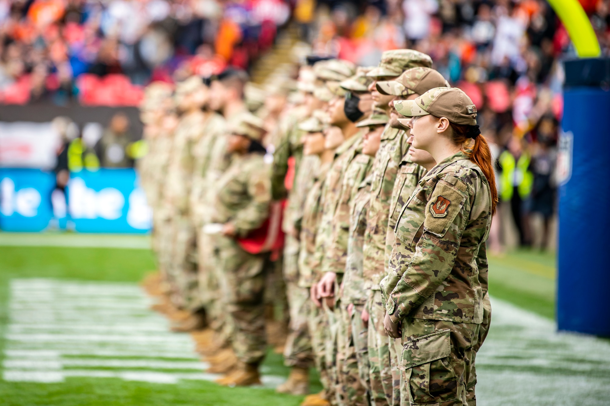 Airmen from the 501st Combat Support Wing stand at attention prior to the national anthem at Wembley Stadium, in London, England, Oct. 30, 2022. Approximately 70 uniformed personnel represented the U.S. Air Force and nation by unveiling an American flag during the pre-game ceremonies of the Jacksonville Jaguars and Denver Broncos NFL game. (U.S. Air Force photo by Staff Sgt. Eugene Oliver)
