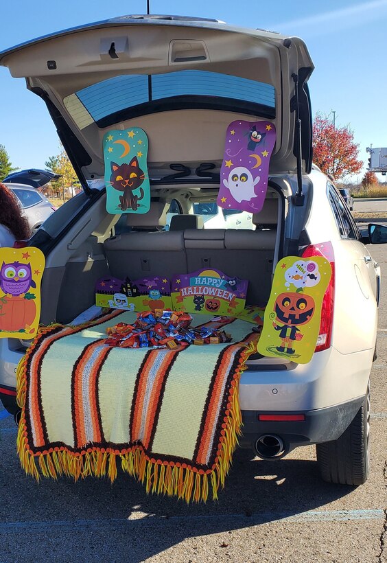 A trunk filled with treats and clown-like decorations.