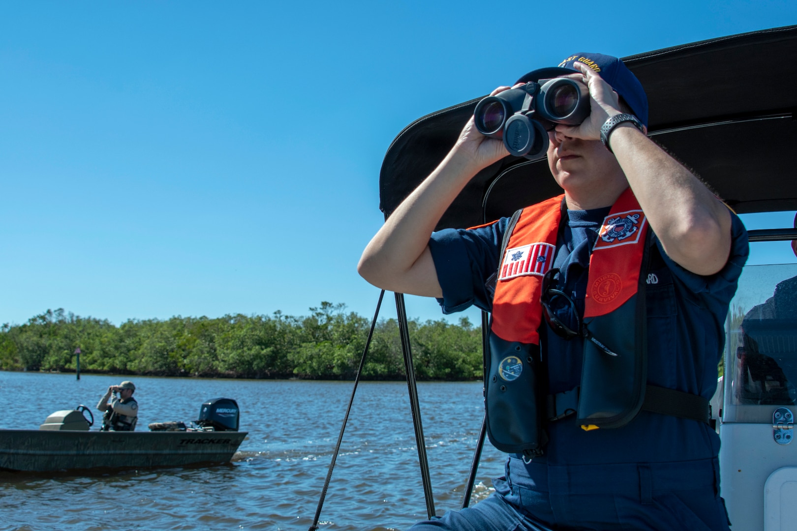 Coast Guard Lt. j.g. Sarah Dupre and Florida Fish and Wildlife Conservation Commission officials assess possible pollution threats from derelict vessels and marine debris from Hurricane Ian, Estero, Florida, Oct. 28, 2022.