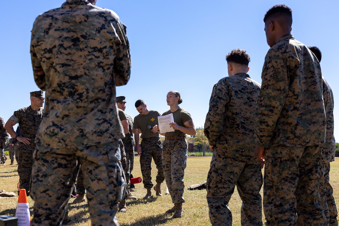 U.S. Marine Corps Cpl. Morgan Poland with Headquarters Battalion, Marine Force Reserve, gives a safety brief prior to a pugil stick competition at Marine Corps Support Facility New Orleans, Oct. 26, 2022. The annual pugil stick "King of the Ring" competition is held to foster the spirit of competition and camaraderie within the unit through friendly competition. (U.S. Marine Corps photo by Sgt. Juan Carpanzano)