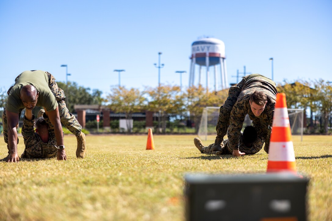 U.S. Marines with Headquarters Battalion, Marine Force Reserve, take part in a pugil stick competition at Marine Corps Support Facility New Orleans, Oct. 26, 2022. The annual pugil stick "King of the Ring" competition is held to foster the spirit of competition and camaraderie within the unit through friendly competition. (U.S. Marine Corps photo by Sgt. Juan Carpanzano)