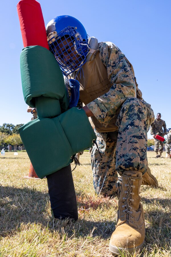 A U.S. Marine with Headquarters Battalion, Marine Force Reserve, takes part in a pugil stick competition at Marine Corps Support Facility New Orleans, Oct. 26, 2022. The annual pugil stick "King of the Ring" competition is held to foster the spirit of competition and camaraderie within the unit through friendly competition. (U.S. Marine Corps photo by Sgt. Juan Carpanzano)
