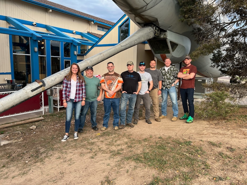 Members of the 168th Wing stand next to the KC-97 Stratofreighter for a photo after installing the refueling boom. The members volunteered to attach the refueling boom as a community service project to honor the aircraft's legacy while attending a leadership course in Colorado Springs, Colorado. (Courtesy photo)