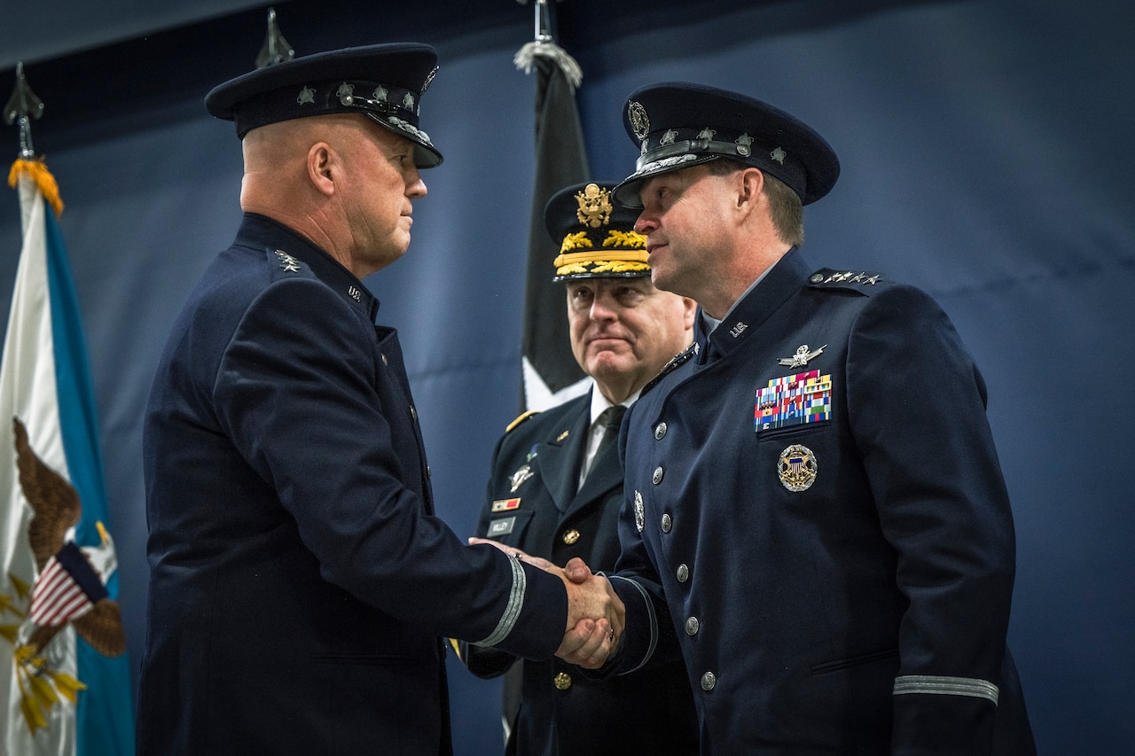 Two men shake hands.