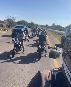 People on motorcycles stopped on a road