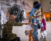 Senior Master Sgt. Nicholas Roberts, 91st Missile Security Operations Squadron senior enlisted leader, interacts with trick-or-treaters during the 91st Security Forces Groups Trunk-or-Treat event at Minot Air Force Base, North Dakota, Oct. 28, 2022. The annual Trunk-or-Treat event was made possible by numerous volunteers across the 91 SFG. (U.S. Air Force photo by Master Sgt. Ryan Bell)