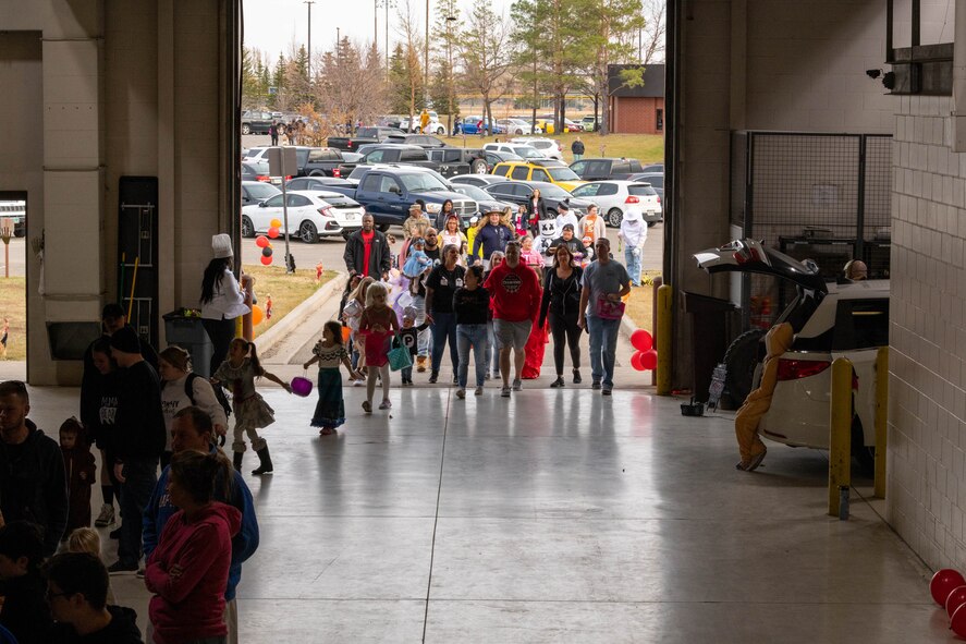 Families arrive to partake in the 91st Security Forces Groups Trunk-or-Treat event at Minot Air Force Base, North Dakota, Oct. 28, 2022. The annual Trunk-or-Treat event was made possible by numerous volunteers across the 91 SFG. (U.S. Air Force photo by Master Sgt. Ryan Bell)