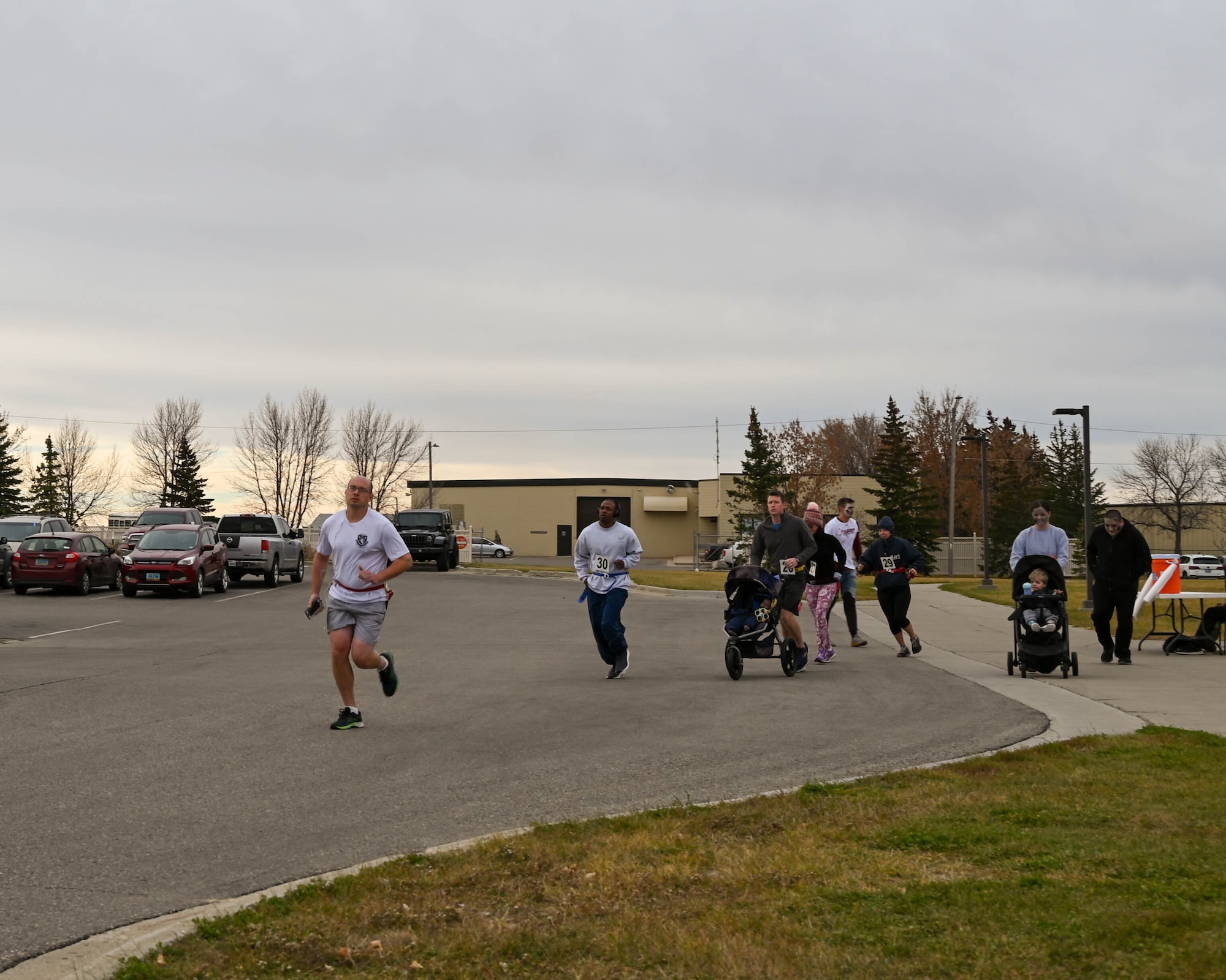 Competitors begin the Zombie 5k Run Oct. 31, 2022 at Minot Air Force Base, N.D. During the run, participants wore flags on their waists and the zombies attempted to take flags. (U.S. Air Force photo by Senior Airman Evan Lichtenhan)