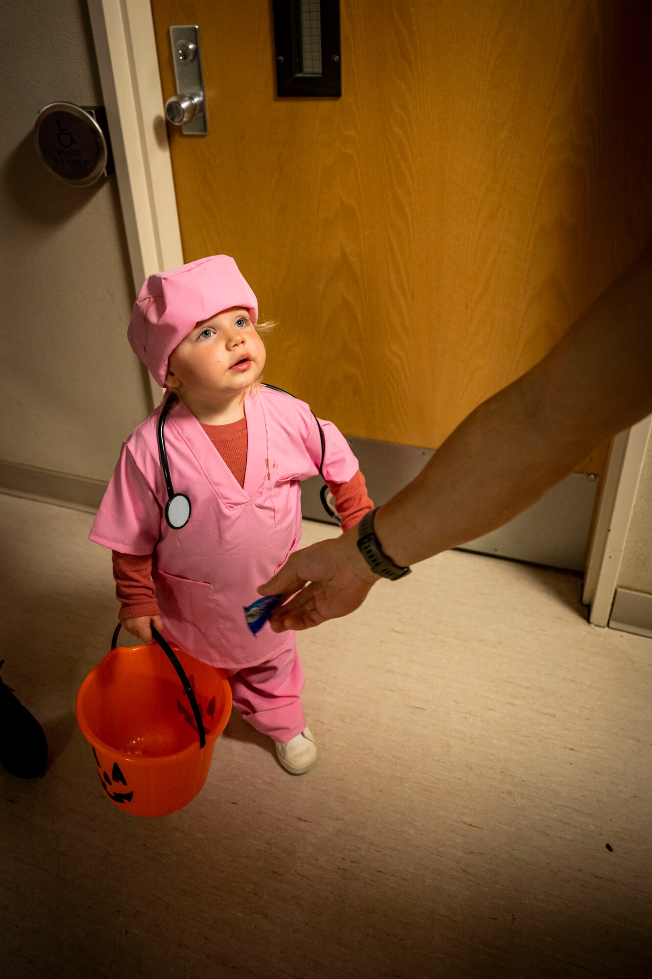 A young child participates in the Trail of Terror hosted by the 5th Medical Group, at Minot Air
Force Base, Oct. 28, 2022. Members from the 5th MDG dressed in Halloween costumes and
escorted children and their families throughout the medical building, stopping from clinic to
clinic. (U.S. Air Force photo by Senior Airman China M. Shock)