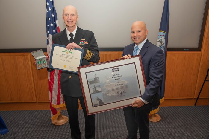 Naval Surface Warfare Center, Philadelphia Division (NSWCPD) Commanding Officer Capt. Dana Simon presents the Lifetime Achievement Award to Eric McFetridge, the Large Marine Gas Turbine Engine Depot Lead Engineer, for his demonstrated technical and program management excellence in support of the Marine Propulsion Program. NSWCPD employees were recently honored during the Command’s 2022 Command Awards Ceremony. (U.S. Navy Photo by Jermaine Sullivan/Released)