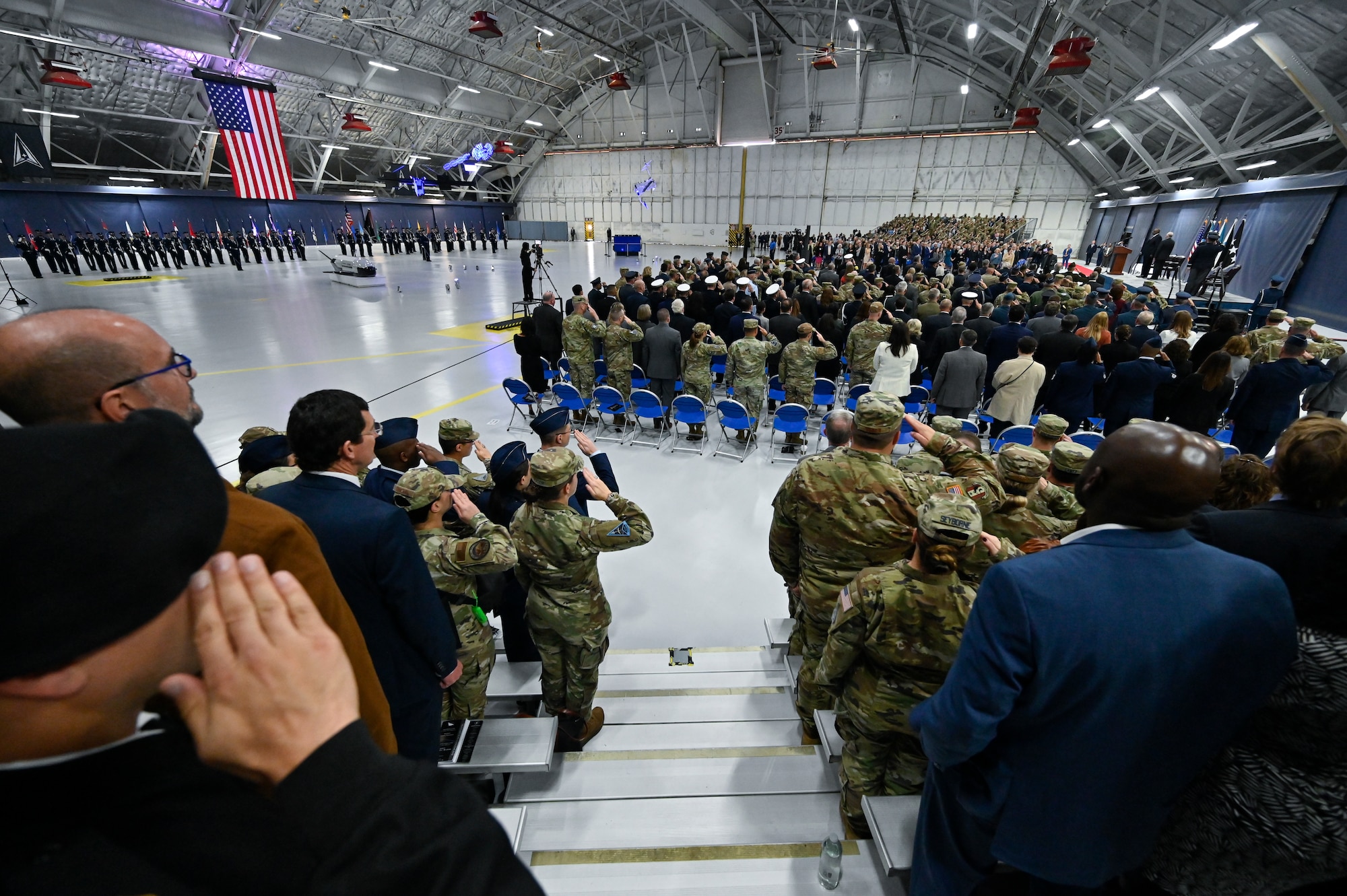 Guests salute for the national anthem during the transition ceremony for the chief of space operations at Joint Base Andrews, Md., Nov. 2, 2022. Gen. Chance Saltzman relieved Gen. John W. “Jay” Raymond as the second CSO, the senior uniformed officer heading the Space Force. (U.S. Air Force photo by Eric Dietrich)