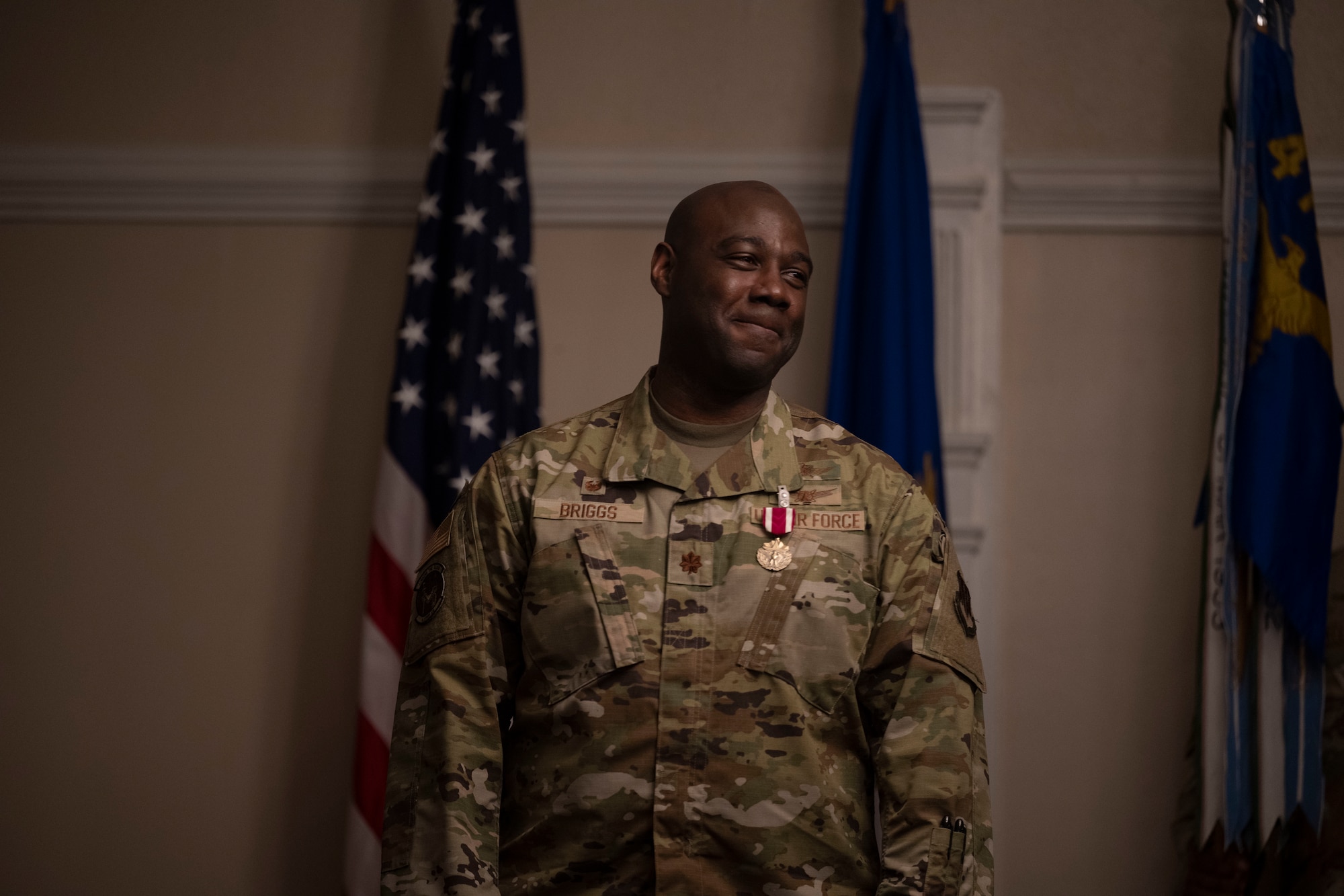 Maj. Terrence Briggs, outgoing 4th Communications Squadron commander, smiles after receiving the Meritorious Service Medal during the 4th CS change of command ceremony at Seymour Johnson Air Force Base, North Carolina, Oct. 28, 2022. The Meritorious Service Medal is awarded to members of the armed services who distinguish themselves by outstanding service to the United States. (U.S. Air Force photo by Senior Airman Kevin Holloway)