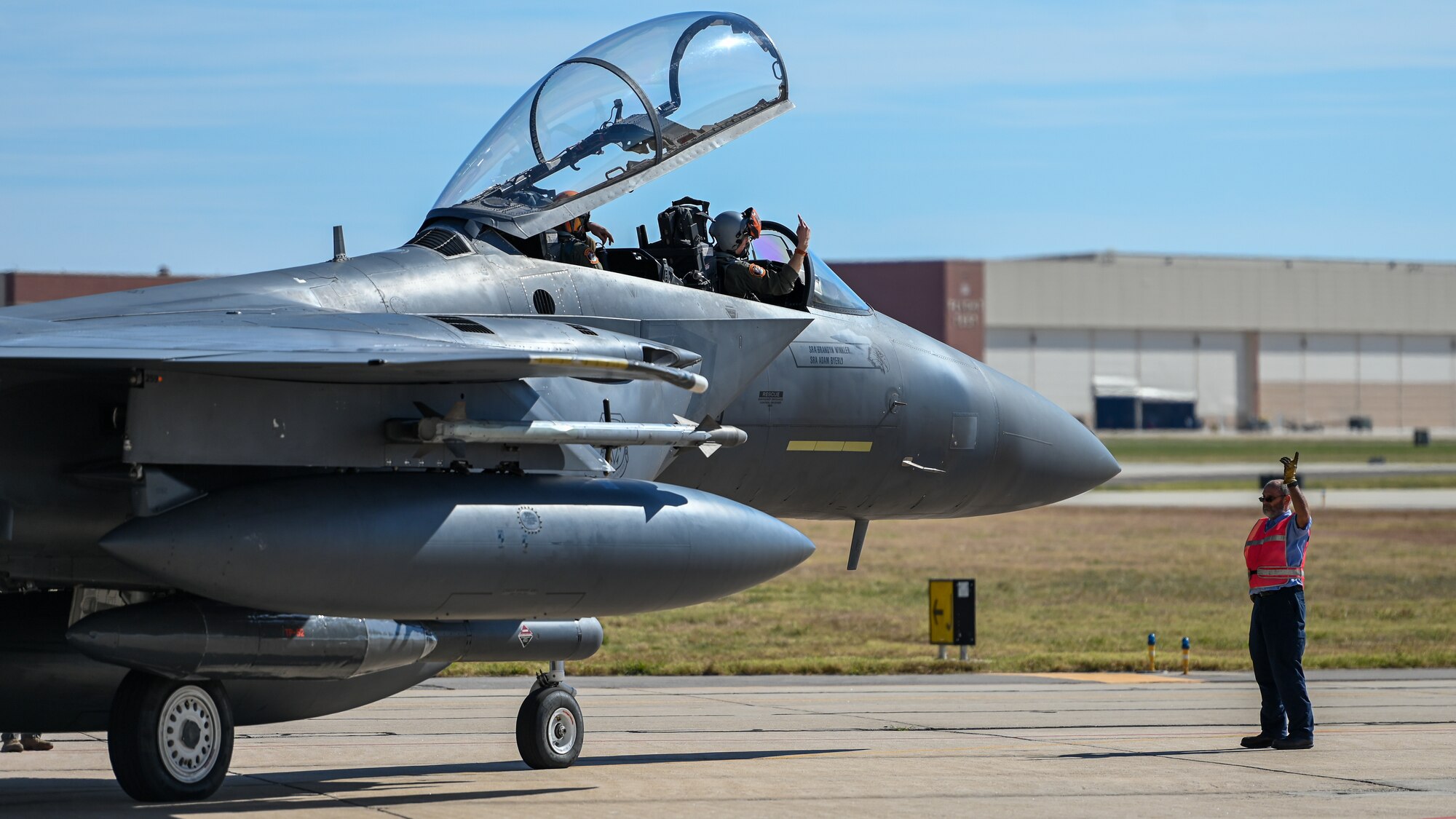 F-15 pilot performing pre-flight checks with ground crew