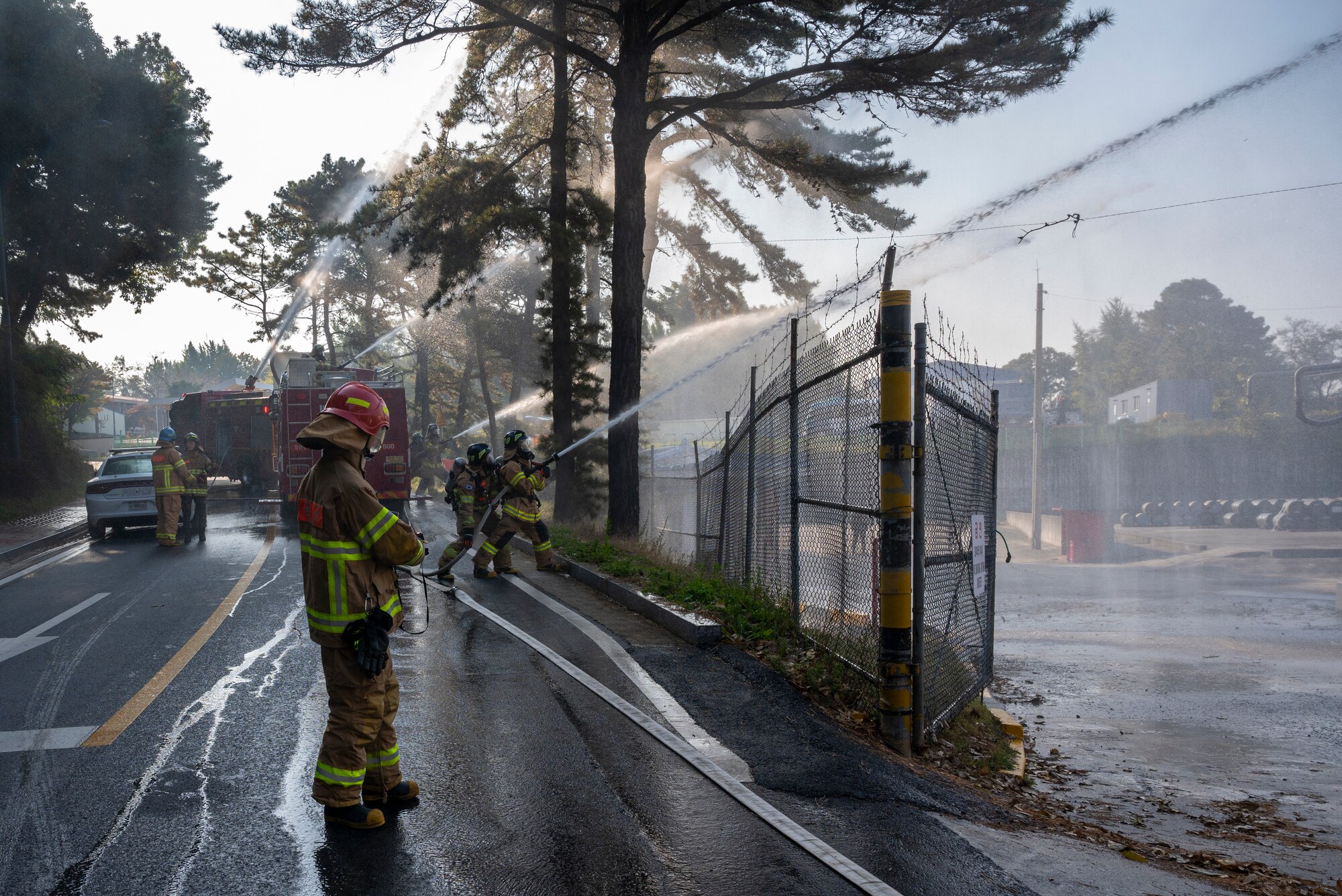 Republic of Korea Air Force firefighters spray water on a simulated fire during a joint training exercise with the 51st Civil Engineer Squadron Fire Department at Osan Air Base, ROK, Oct. 27, 2022.