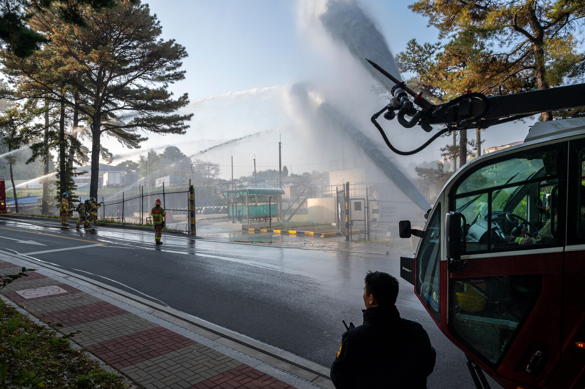 Republic of Korea Air Force firefighters and the 51st Civil Engineer Squadron Fire Department spray water on a simulated fire during a joint training exercise at Osan Air Base, ROK, Oct. 27, 2022.