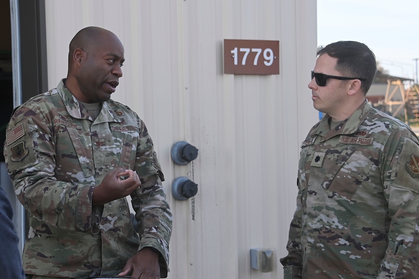 Col. Todd E. Randolph (left), 316th Wing and installation commander, speaks with Lt. Col. Timothy Hubler (right), 316th Logistics Readiness Squadron commander, prior to a cargo deployment function training exercise at Joint Base Andrews, Md., Nov. 2, 2022. The training allowed four vehicles with additional equipment to be processed for debarkation in an effort to familiarize everyone with processes.(U.S. Air Force photo by Staff Sgt. Spencer Slocum)