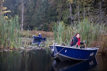 Tulalip Tribes Natural Resources wildlife biologist Annalei Lees transports a trapped North American beaver on a boat at Naval Radio Station Jim Creek, Washington, Oct. 12.