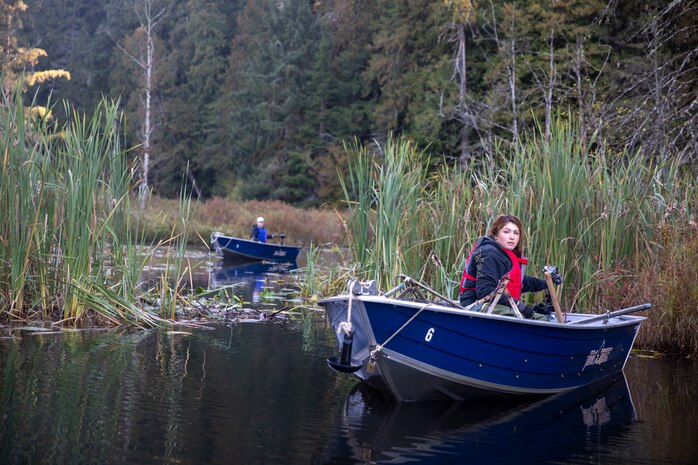 Tulalip Tribes Natural Resources wildlife biologist Annalei Lees transports a trapped North American beaver on a boat at Naval Radio Station Jim Creek, Washington, Oct. 12.