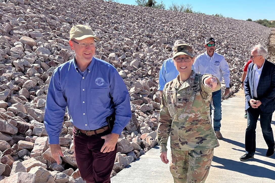 Col. Julie A. Balten, Los Angeles District commander, front right, discusses the successful completion of a flood-control project for Maricopa County with Michael Fulton, director of the Maricopa County Flood Control District, left, during an Oct. 25 visit to the New River Dam Outlet Channel in Florence, Arizona.