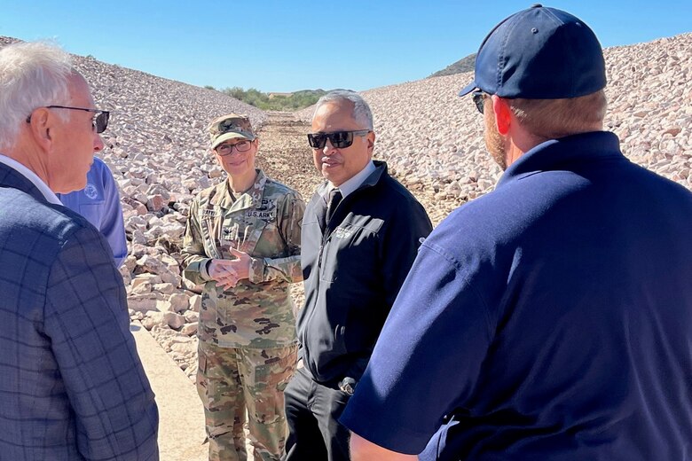 Col. Julie A. Balten, Los Angeles District commander, center left, listens to representatives with Maricopa County discuss the benefits of the New River Dam Outlet Channel project completion during an Oct. 25 visit to the site in Florence, Arizona.