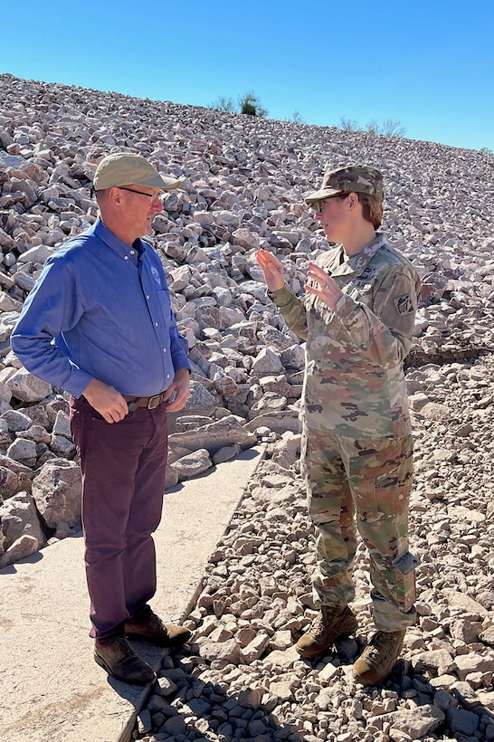 Col. Julie A. Balten, Los Angeles District commander, right, discusses the completion of a flood-control project in Maricopa County with Michael Fulton, director of the Maricopa County Flood Control District, left, during an Oct. 25 visit to the New River Dam Outlet Channel in Florence, Arizona.