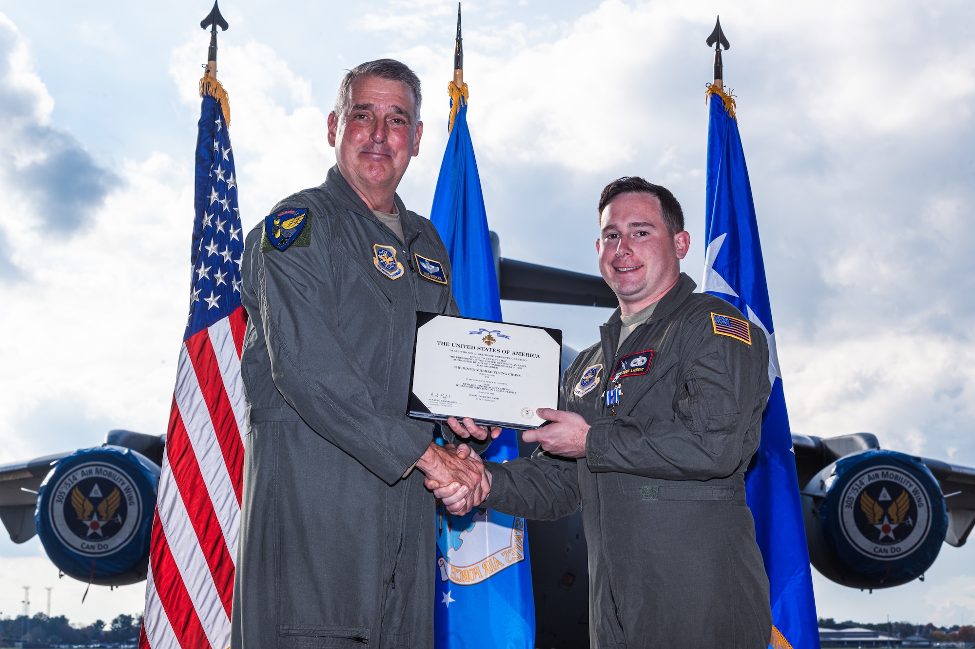 U.S. Air Force Staff Sgt. Derek Laurent, 305th Aircraft Maintenance Squadron flying crew chief, is awarded the distinguished flying cross with valor by Gen. Mike Minihan, Air Mobility Command commander, on Joint Base McGuire-Dix-Lakehurst, N.J., Nov. 1, 2022. The distinguished flying cross with valor is one of the highest awards for extraordinary achievement and is awarded for heroism while participating in aerial flight. (U.S. Air Force photo by Senior Airman Joseph Morales)