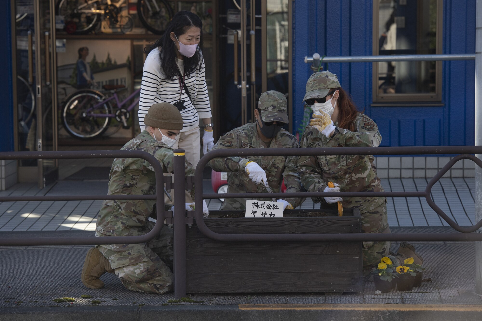 Members assigned to the 374th Airlift Wing public affairs office plant flowers during a city beautification project at Fussa City, Japan, Oct. 31, 2022. The project was an opportunity for Team Yokota to work side-by-side with members of the local community and strengthen its ties and friendship with Japanese neighbors outside the gates. (U.S. Air Force photo by Tech. Sgt. Christopher Hubenthal)