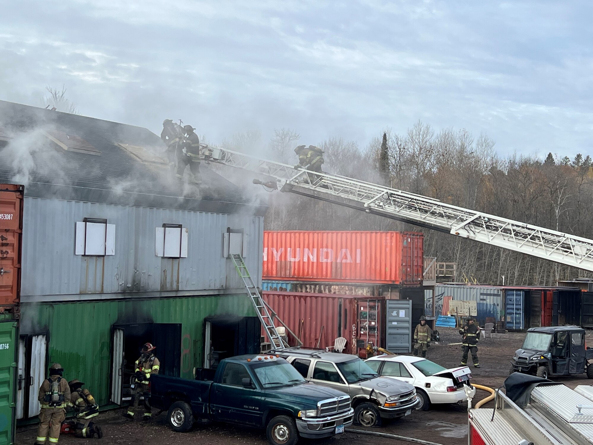 Newly hired fire fighters assigned to the 148th Fighter Wing, Minnesota Air National Guard Fire Department, Duluth Fire Department, and Superior Fire Department respond to a structure fire during a training live fire evolution at Lake Superior College's Emergency Response Training Center, Duluth, Minnesota, October 27, 2022.