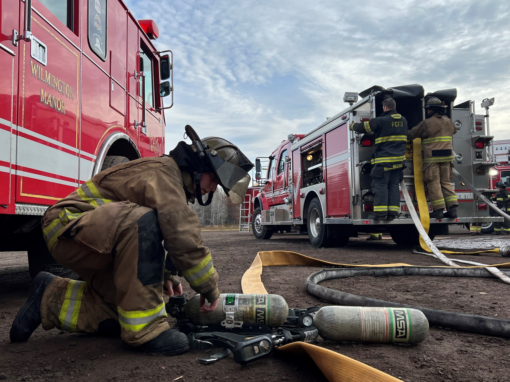 A fire fighter assigned to the 148th Fighter Wing, Minnesota Air National Guard reservices his air pack after a structure fire during a training live fire evolution at Lake Superior College's Emergency Response Training Center, Duluth, Minnesota, October 27, 2022.