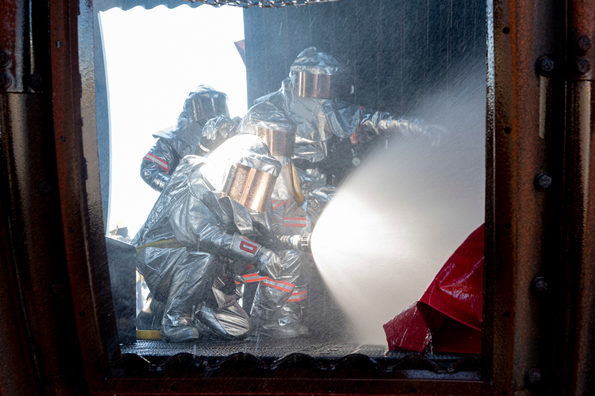 Japan Air Self-Defense Force firefighters spray water on an aircraft fire simulator during a bilateral training with the 374th Civil Engineer Squadron at Yokota Air Base, Japan, Oct. 26, 2022.
