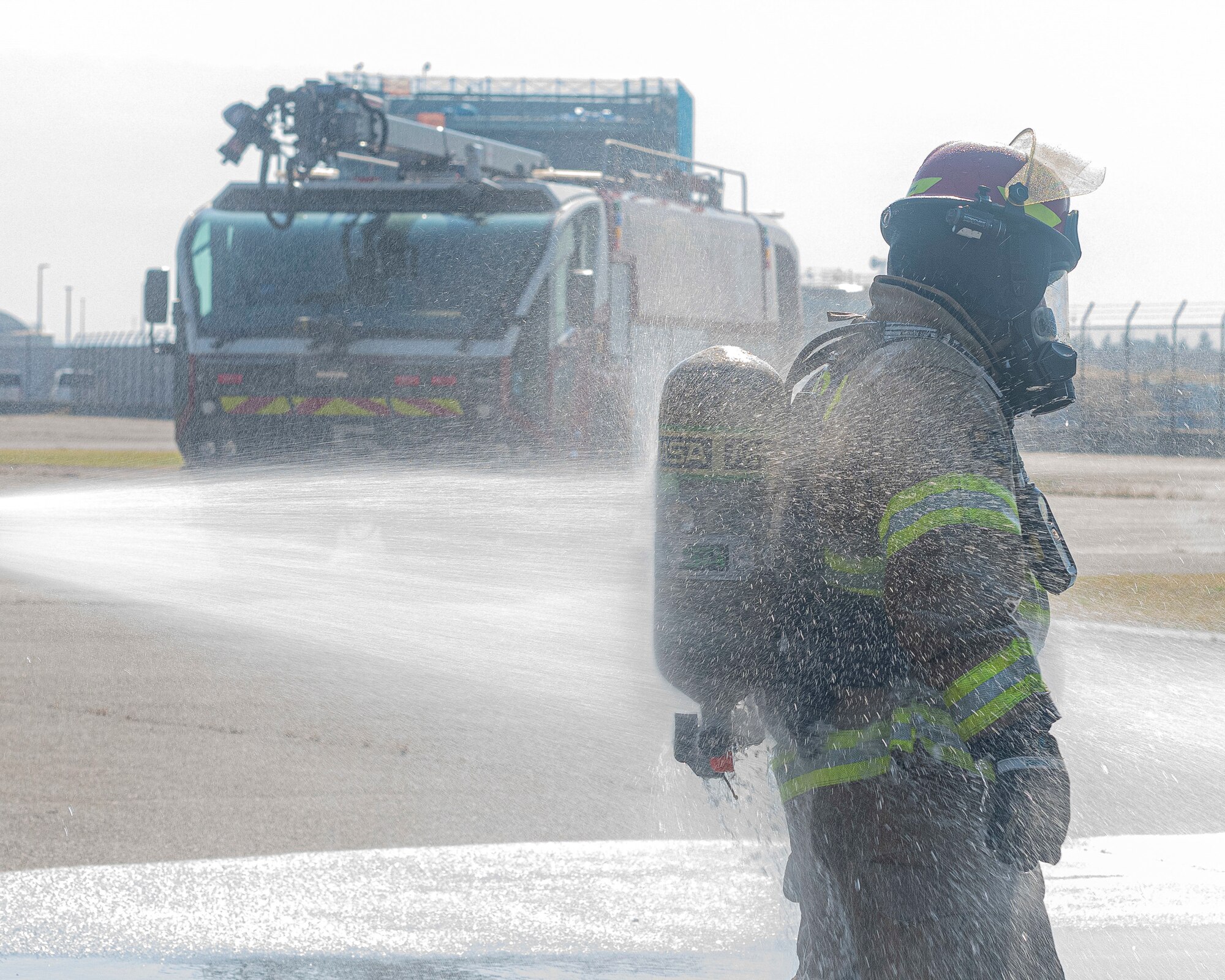 A firefighter with the 374th Civil Engineer Squadron is sprayed down to remove soot during a bilateral training with the Japan Air Self-Defense Force at Yokota Air Base, Japan, Oct. 28, 2022.
