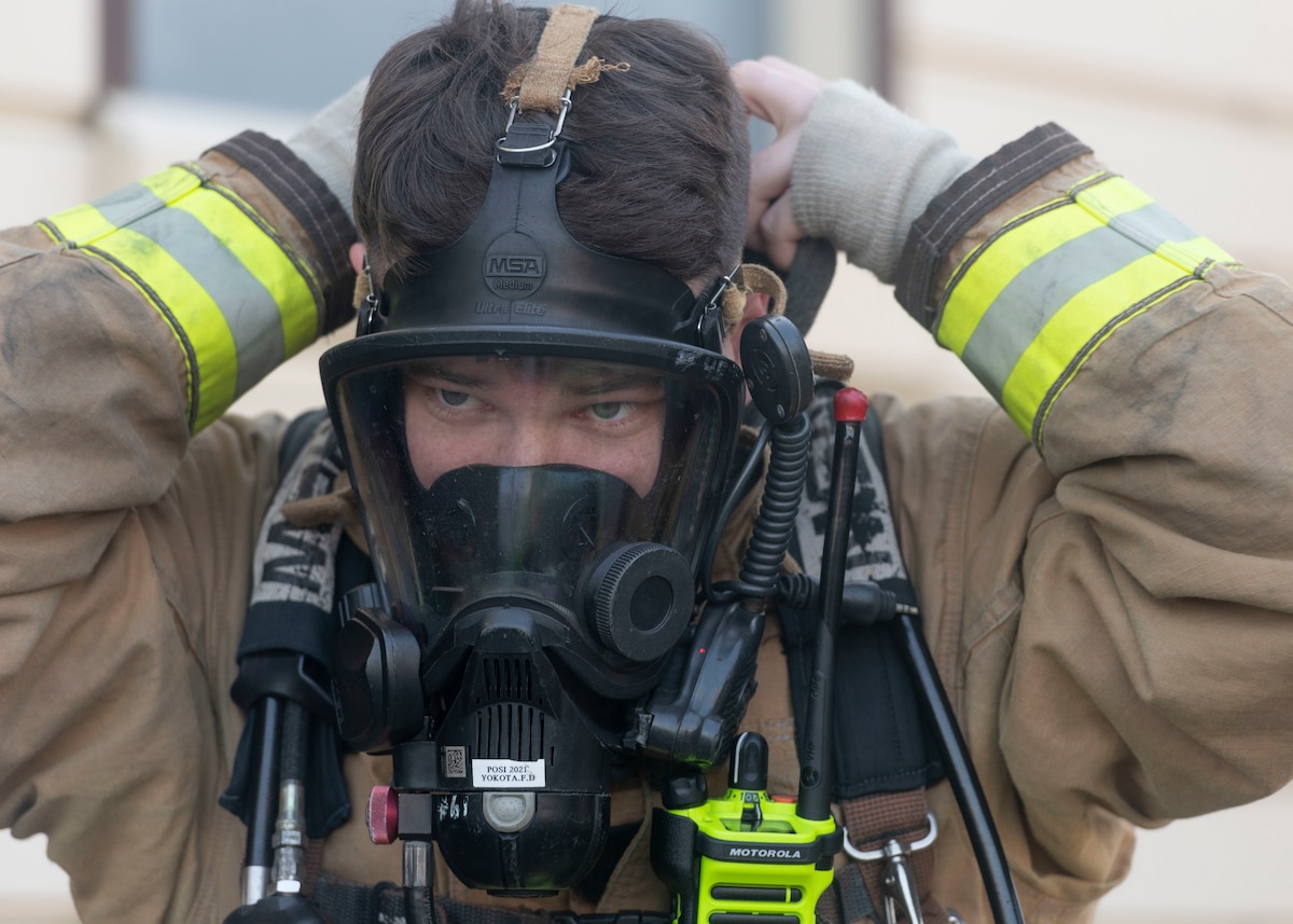 Staff Sgt. Thomas Reno, 374th Civil Engineer Squadron fire truck operator, puts on his fire protection gear during a bilateral training with the Japan Air Self-Defense Force at Yokota Air Base, Japan, Oct. 28, 2022.