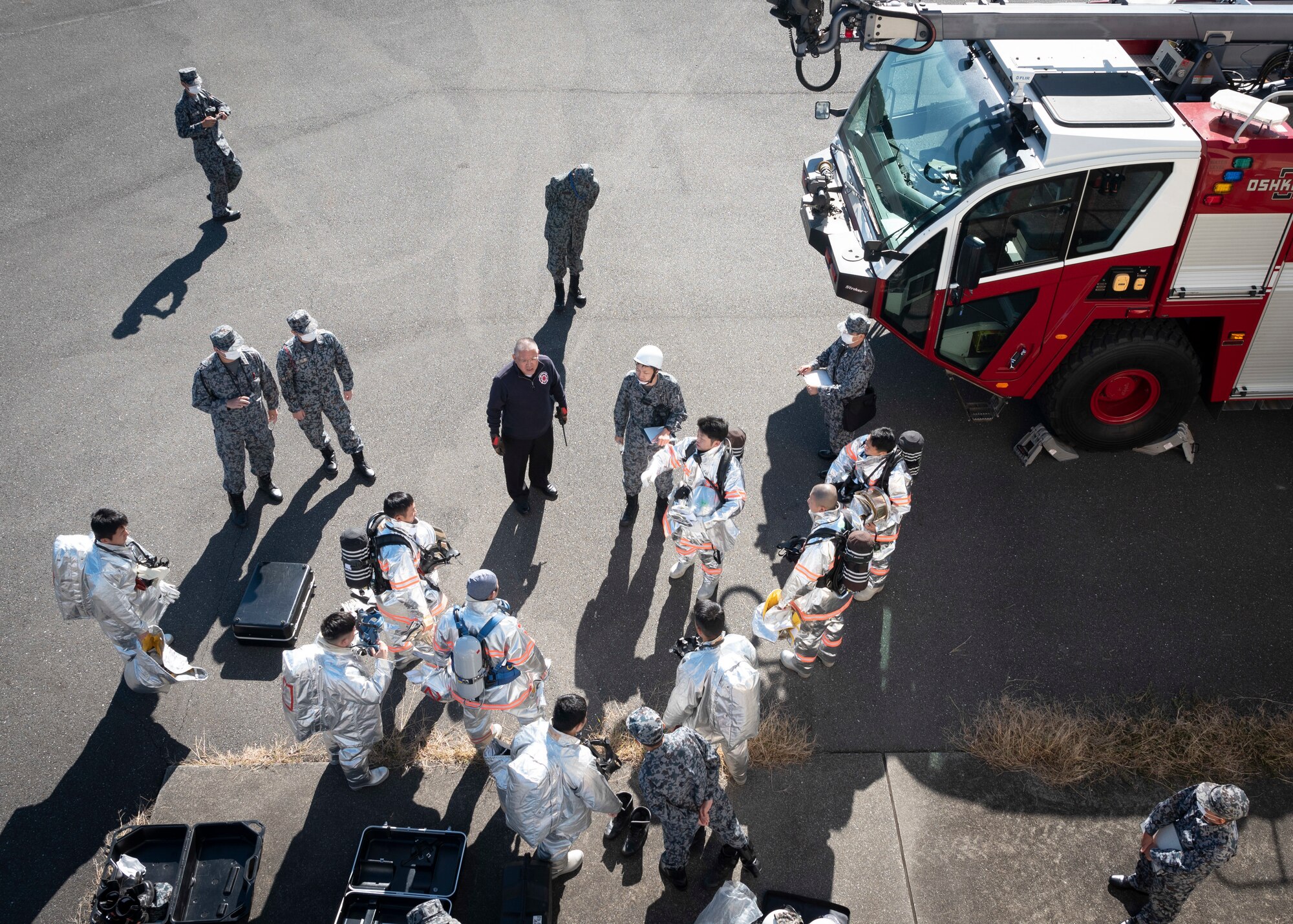 Japan Air Self-Defense Force firefighters listen to a brief during a bilateral training with the 374th Civil Engineer Squadron at Yokota Air Base, Japan, Oct. 26, 2022