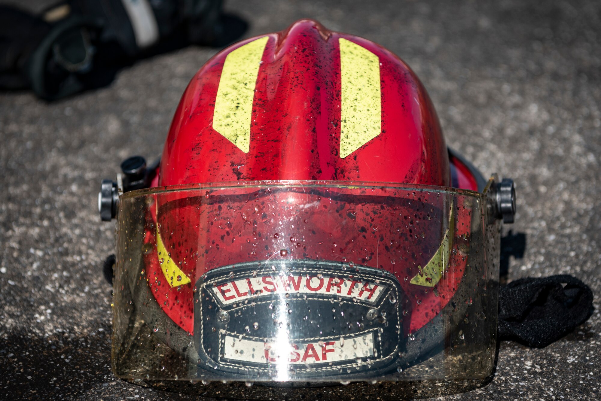 A 374th Civil Engineer Squadron firefighter helmet sits on the ground after a bilateral training on a structural live fire at Yokota Air Base, Japan, Oct. 28, 2022.