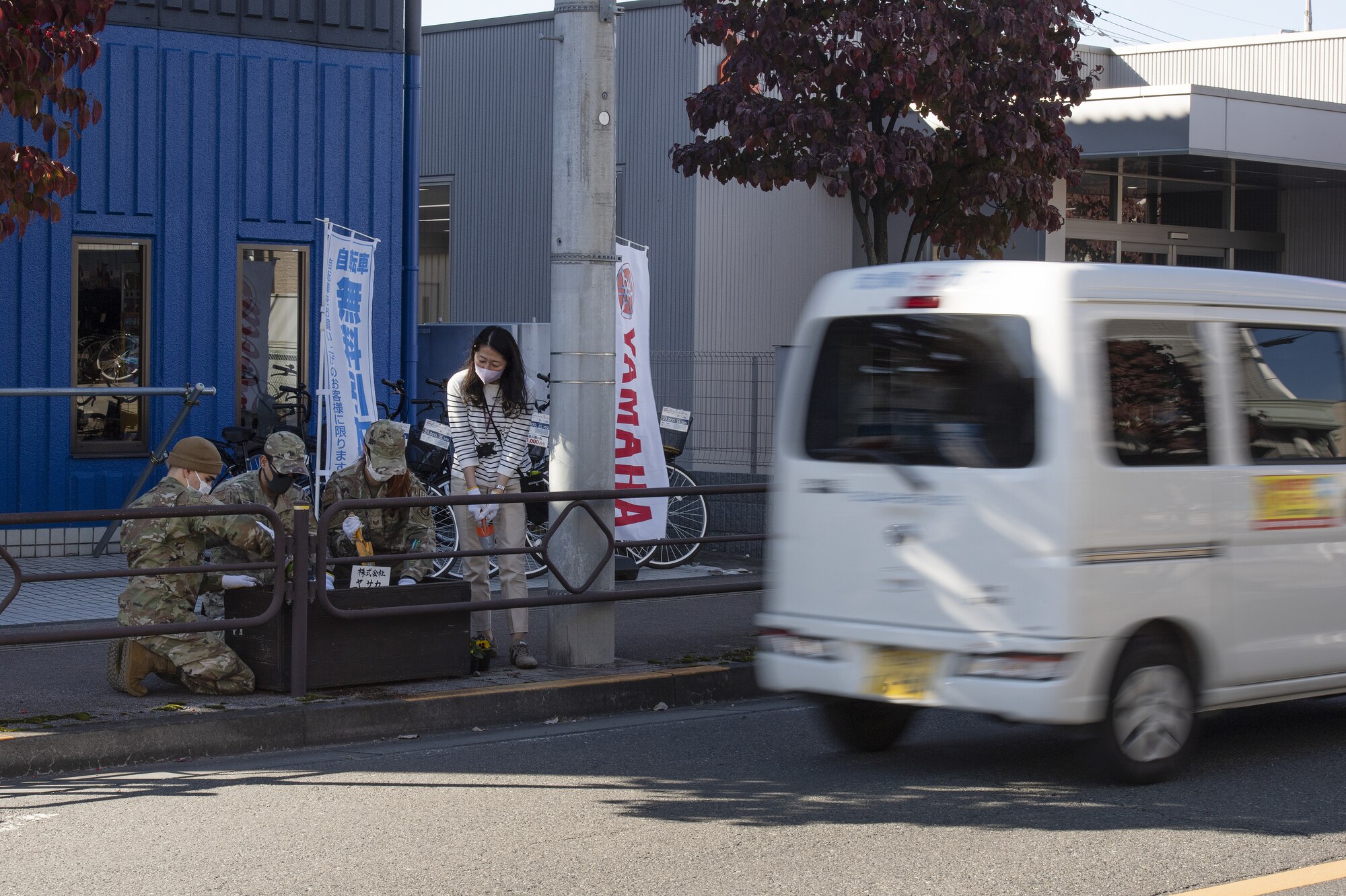 Members assigned to the 374th Airlift Wing public affairs office plant flowers during a city beautification project at Fussa City, Japan, Oct. 31, 2022. The project was an opportunity for Team Yokota to work side-by-side with members of the local community and strengthen its ties and friendship with Japanese neighbors outside the gates. (U.S. Air Force photo by Tech. Sgt. Christopher Hubenthal)