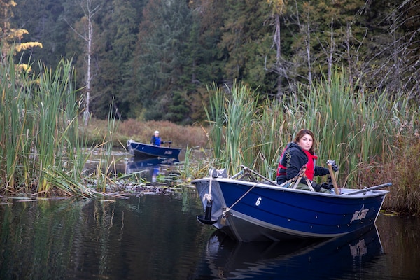Tulalip Tribes Natural Resources wildlife biologist Annalei Lees transports a trapped North American beaver on a boat at Naval Radio Station Jim Creek, Washington, Oct. 12.