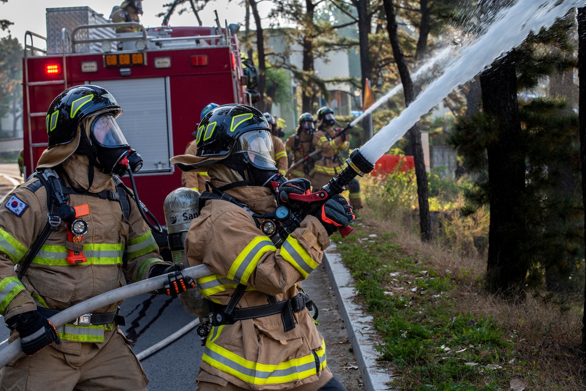 Republic of Korea Air Force firefighters spray water on a simulated fire during a joint training exercise with the 51st Civil Engineer Squadron Fire Department at Osan Air Base, ROK, Oct. 21, 2022.