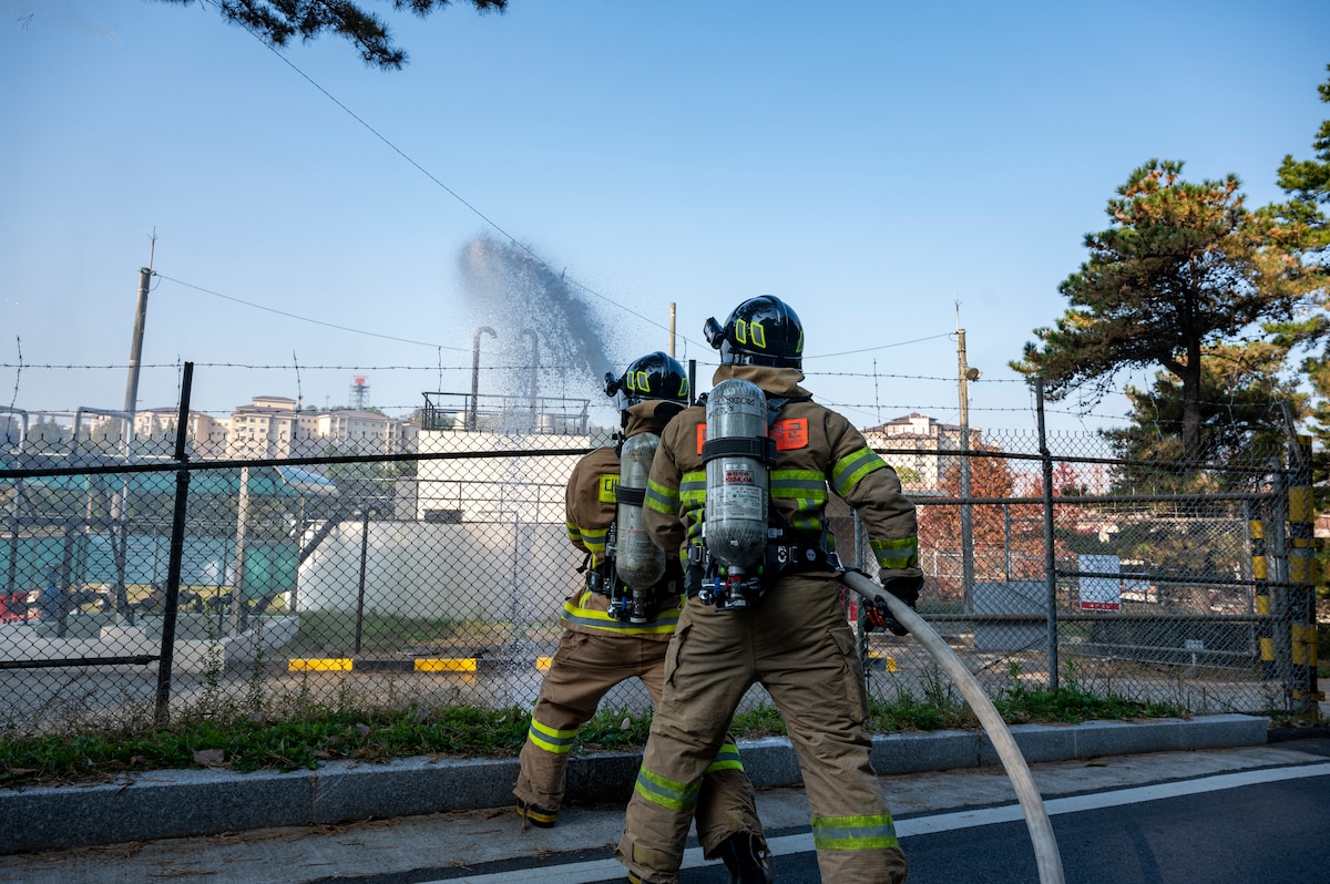 Republic of Korea Air Force firefighters spray water on a simulated fire during a joint training exercise with the 51st Civil Engineer Squadron Fire Department at Osan Air Base, ROK, Oct. 27, 2022.