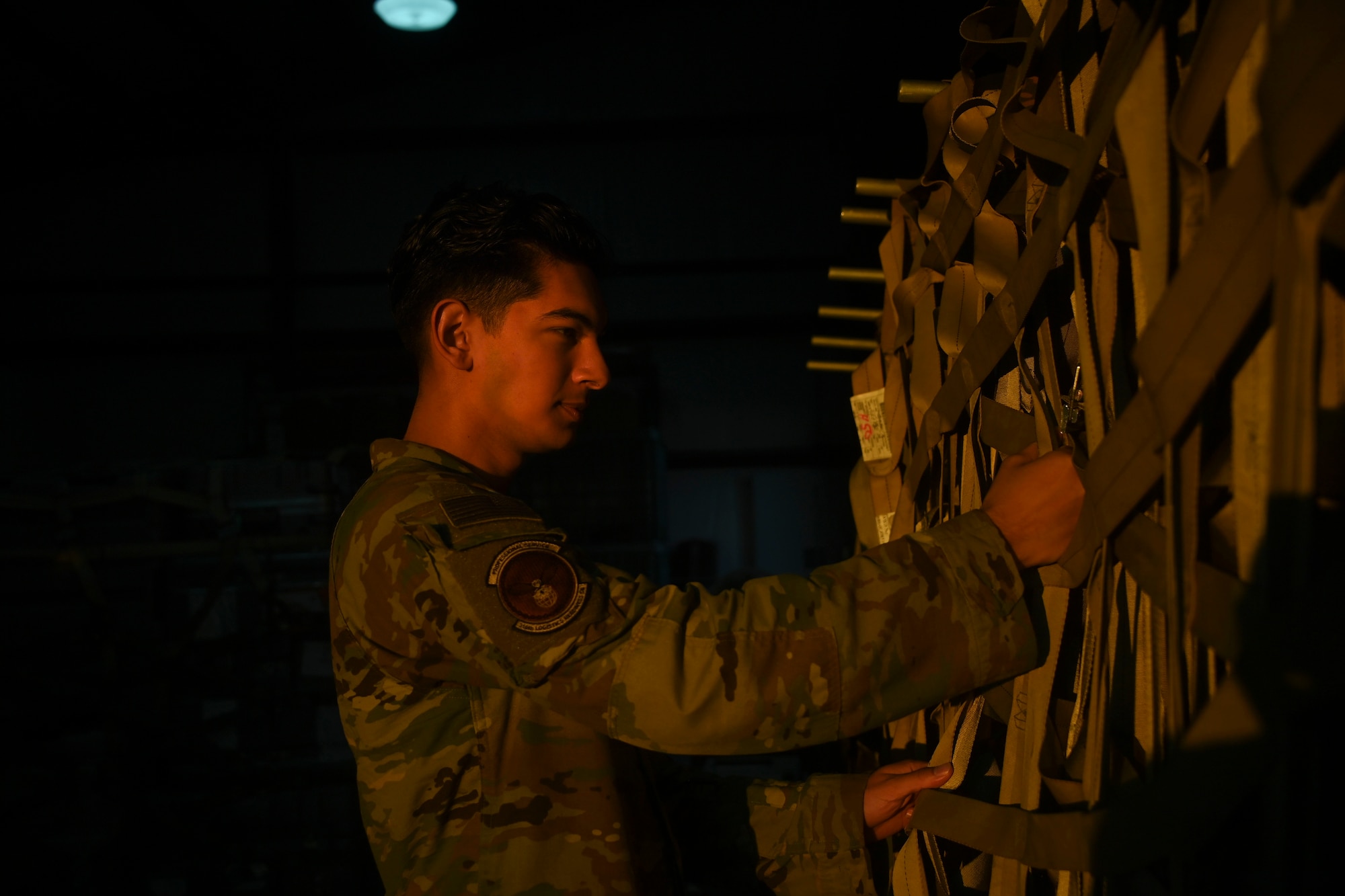 Airman 1st Class Ryan Maclaren, 316th Logistics Readiness Squadron vehicle operator, checks the tightness of cargo straps prior to a training exercise at Joint Base Andrews, Md., Nov. 2, 2022. The cargo deployment function enables the support of mission partners by fostering communication and the ability to work together on different parts of the same mission to mobilize assets wherever the mission requires. (U.S. Air Force photo by Staff Sgt. Spencer Slocum)