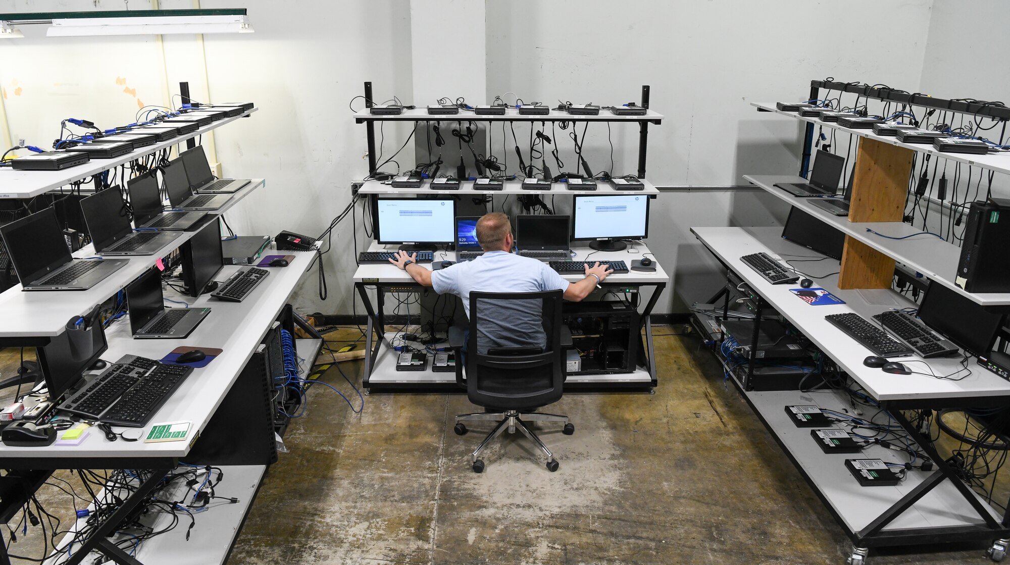 Jonathan Poe, a computer network technician IV, works in the computer staging area