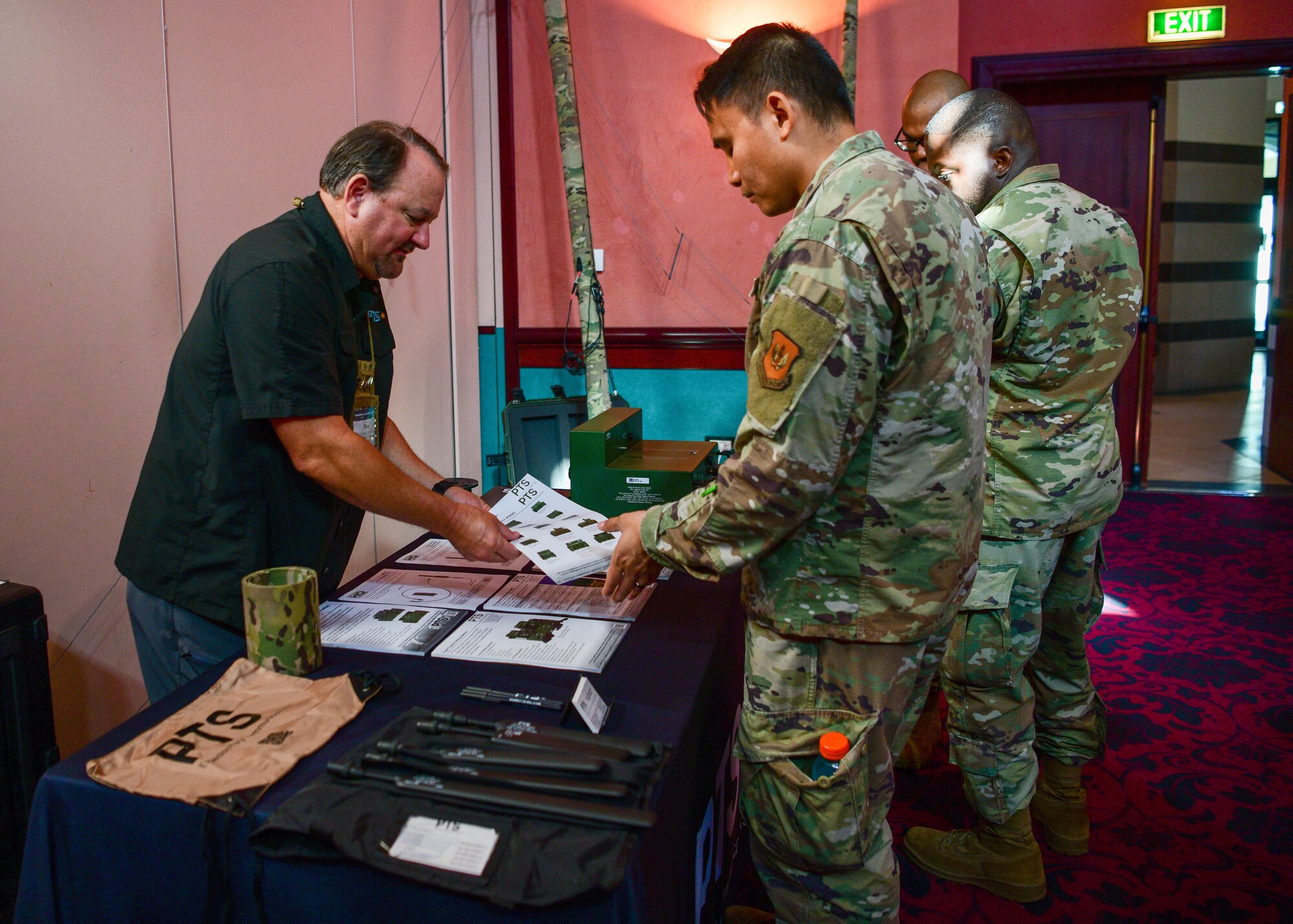 U.S. Airmen inspect products from an industry partner during a Tech Expo hosted by the 31st Communications Squadron at Aviano Air Base, Italy, Oct. 25, 2022. The expo served an opportunity for organizations and units structured under the 31st Fighter Wing and other tenant units to see the latest in emerging technologies, network with industry experts and share ideas and future goals. (U.S. Air Force photo by Senior Airman Brooke Moeder)