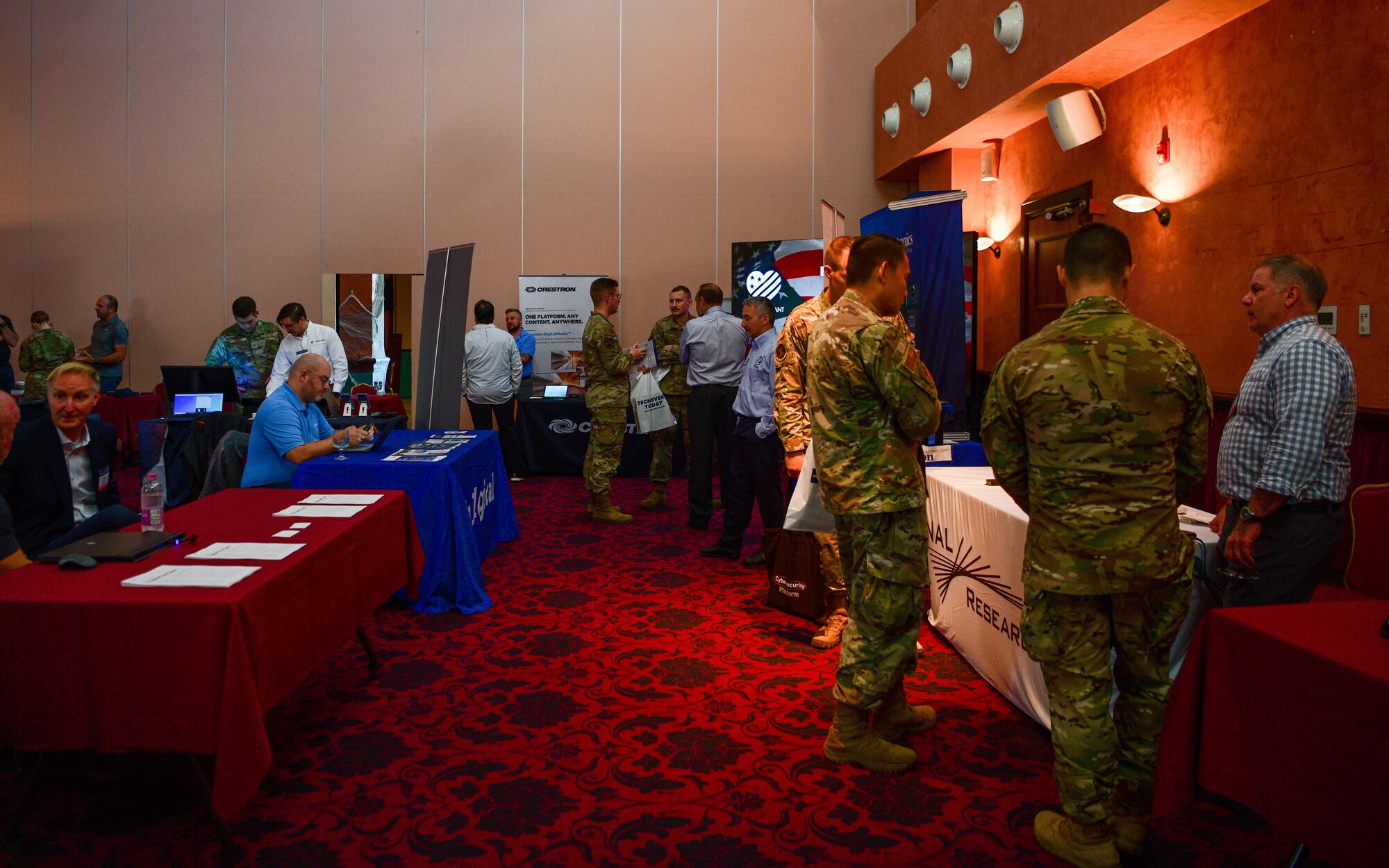 U.S. Airmen look at different stands at a Tech Expo hosted by the 31st Communications Squadron at Aviano Air Base, Italy, Oct. 25, 2022. There were approximately 16 industry partners at the Tech Expo that showcased their products to military members. (U.S. Air Force photo by Senior Airman Brooke Moeder)