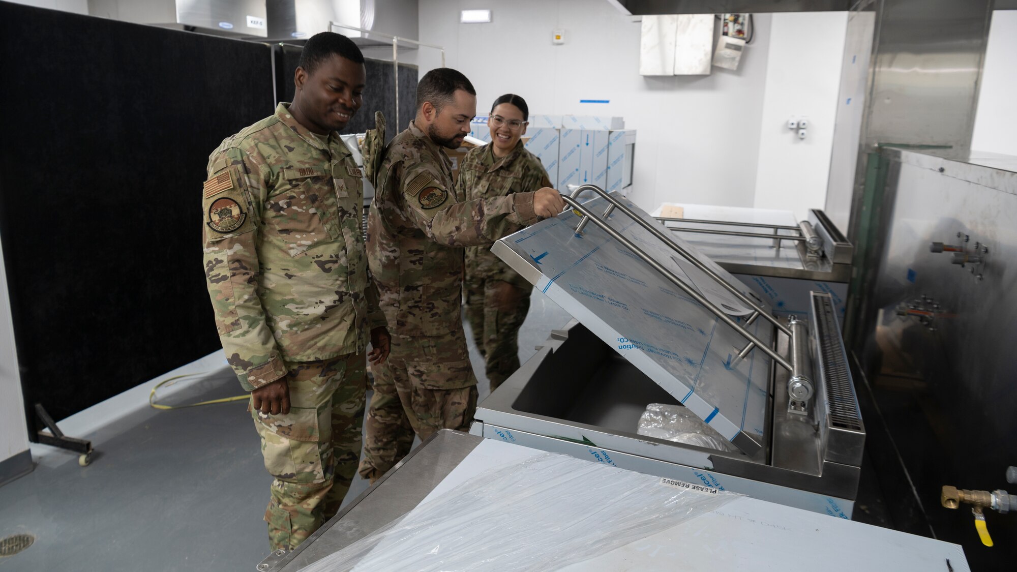 Members of the 332d Expeditionary Contracting Squadron, Commodities, inspect the quality of new purchases for the 332d Air Expeditionary Wing dining facility at an undisclosed location, Southwest Asia, Oct. 13, 2022. ECONS specializes in installation support services, infrastructure requirements, and critical base defense needs. (U.S. Air Force photo by Tech. Sgt. Jeffery Foster)
