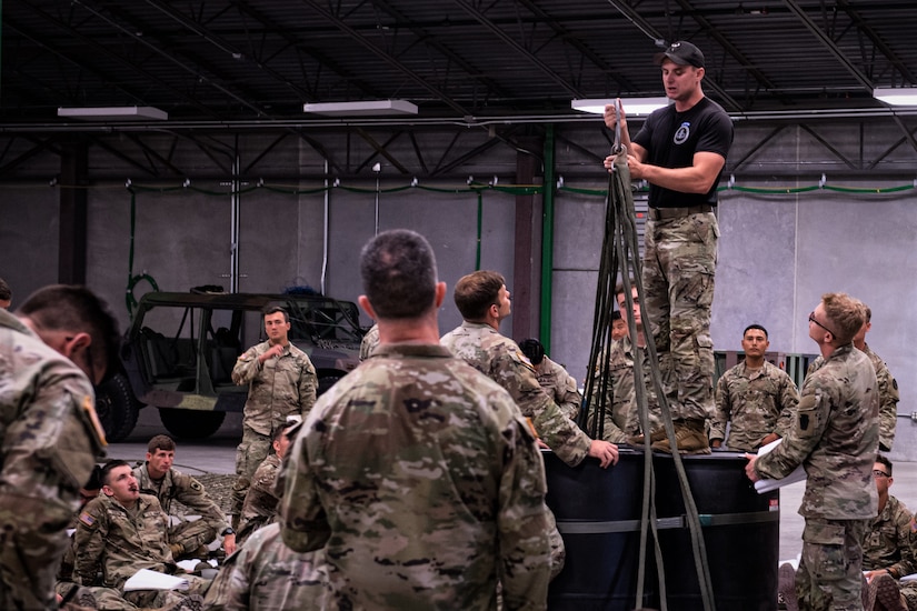 A U.S. Army Air Assault instructor teaches students the proper techniques on preparing equipment and supplies for sling load operations August 6, 2022, at Fort Indiantown Gap, Pennsylvania. Airmen, Soldiers and Marines participated in a two-week long Air Assault course.