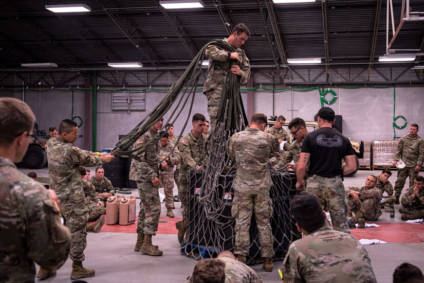 Air Assault students prepare equipment and supplies for sling load operations during training August 6, 2022, at Fort Indiantown Gap, Pennsylvania. Airmen, Soldiers and Marines participated in a two-week long Air Assault course.