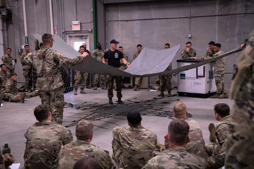 A U.S. Army Air Assault instructor teaches students the proper techniques on preparing equipment and supplies for sling load operations August 6, 2022, at Fort Indiantown Gap, Pennsylvania. Airmen, Soldiers and Marines participated in a two-week long Air Assault course held at Fort Indiantown Gap.