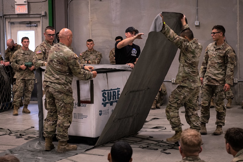 A U.S. Army Air Assault instructor teaches students the proper techniques on preparing equipment and supplies for sling load operations August 6, 2022, in Annville, Pennsylvania. Airmen, Soldiers and Marines participated in a two-week long Air Assault course held at Fort Indiantown Gap.